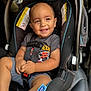 child, toddler, car_seat, smiling, happy, seatbelt, baby, clothing, shorts, shirt, car_interior, safety, cute, portrait, infant, young_child, seat, strapped_in, automobile, baby_boy