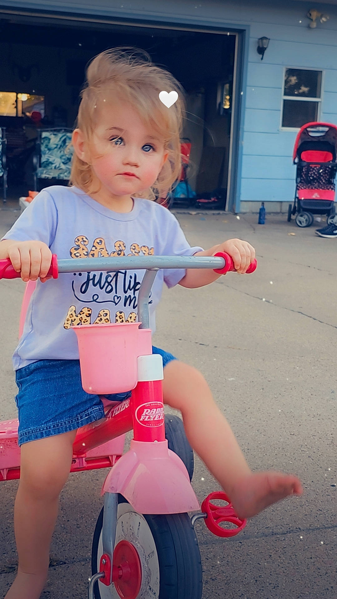 Kyrie is registered to the contest to win money with this photo: baby_toddler_clothing, bicycle, bicycle_accessory, bicycle_tire, child, electric_blue, fun, happy, human_leg, person, photograph, pink, red, riding_toy, shorts, snapshot, thigh, tire, toddler, wheel