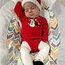 Wrenley joined the competition — help win amazing prizes! baby, infant, sleeping, santa_hat, red_clothing, white_tights, black_socks, cushion, chevron_pattern, holiday, christmas, festive, cozy, indoor, cute, child, resting, soft, newborn, portrait