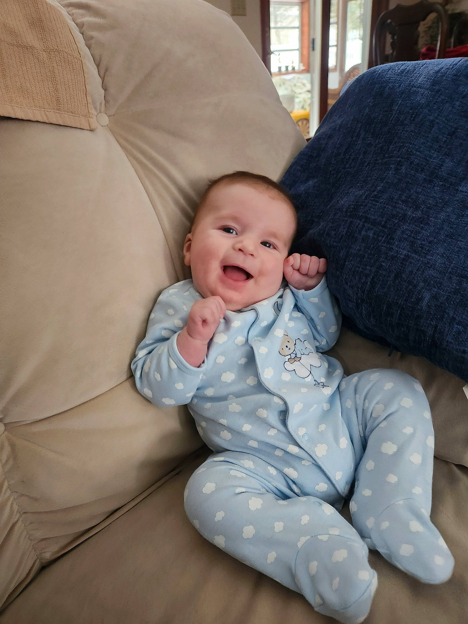 Francis is registered to the contest to win money with this photo: baby, baby_toddler_clothing, cheek, child, comfort, couch, flash_photography, fun, hairstyle, happy, iris, linens, living_room, person, sitting, skin, sleeve, smile, textile, throw_pillow