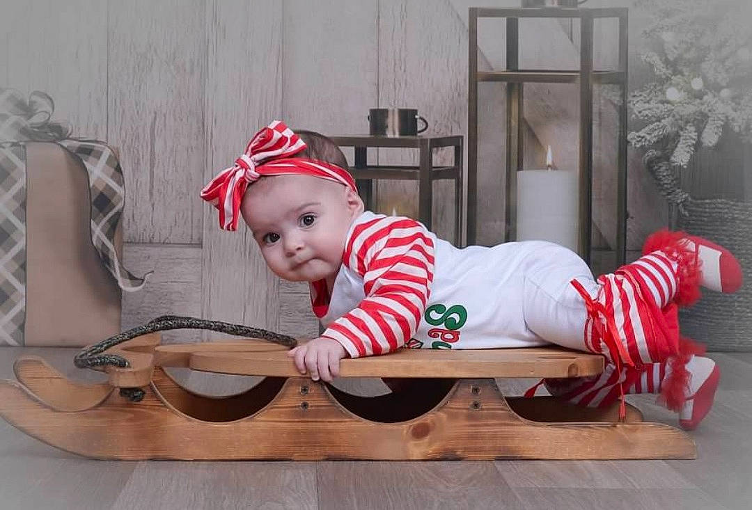 Esperanza joined the competition — help win amazing prizes! baby, baby_toddler_clothing, carmine, child, christmas, christmas_eve, comfort, costume_hat, event, flooring, hat, headwear, holiday, leg, pattern, person, room, sitting, sleeve, sock