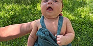 Kingstyn is registered to the contest to win money with this photo: arm, baby, child, cute, daylight, expression, grass, greenery, holding, infant, nature, outdoor, person, portrait, romper, skin, summer, sunlight, trees, young
