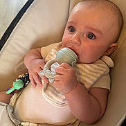 Arlo joined the competition — help win amazing prizes! baby, infant, teether, child, seat, buckle, curious, cute, hand, face, blue_eyes, clothing, bib, toy, indoor, closeup, skin, comfort, expression, young