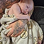 Charles joined the competition — help win amazing prizes! baby, infant, tattoo, arm, blanket, smiley_face, bee, sleeping, skin, hand, person, cuddle, comfort, soft, pattern, closeup, resting, indoor, cozy, nurture