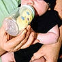 Charles joined the competition — help win amazing prizes! baby, infant, bottle, feeding, hat, black_clothing, hands, adult, arm, skin, closeup, indoor, person, child, cute, portrait, drink, holding, resting, face