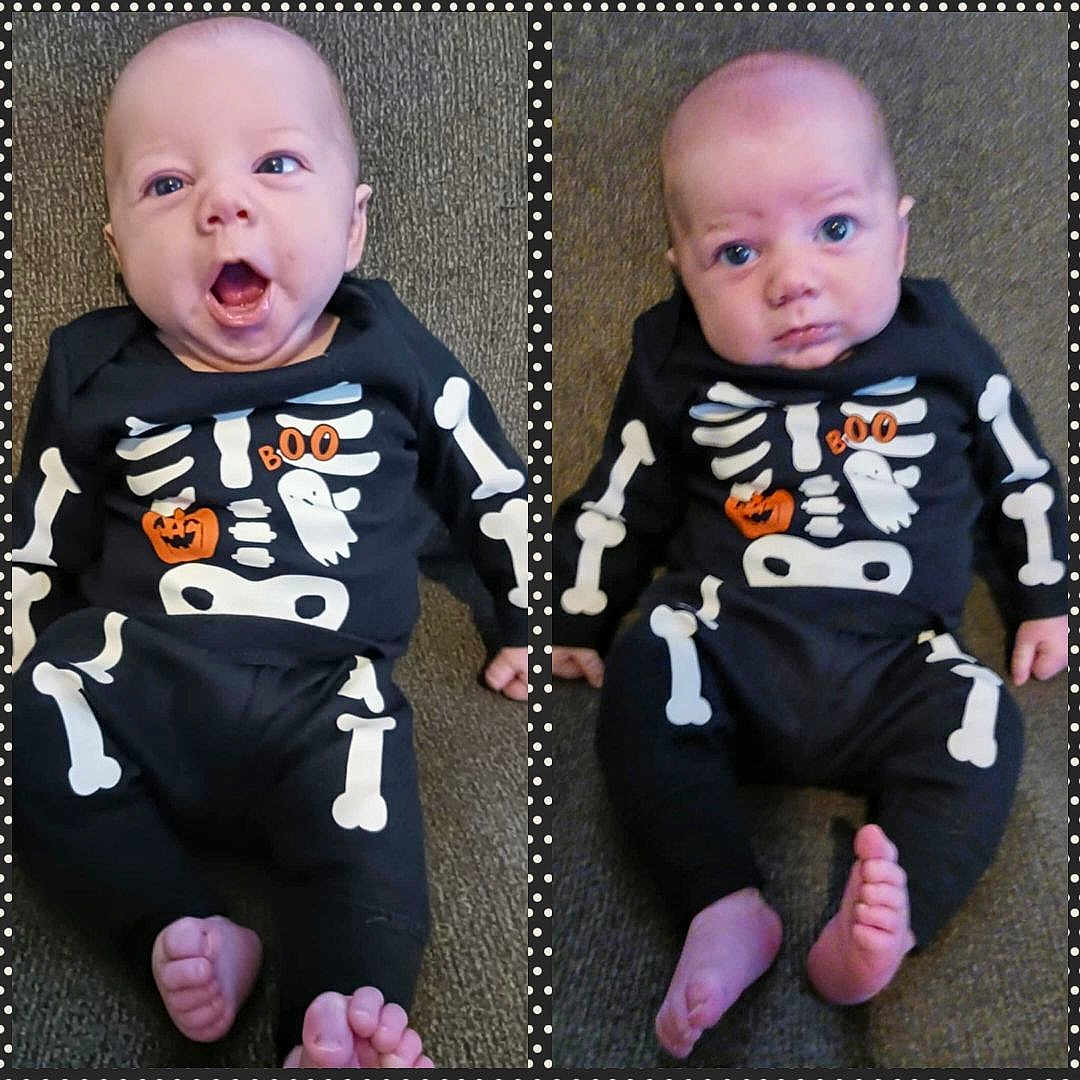 Charles joined the competition — help win amazing prizes! baby, infant, child, halloween, costume, skeleton, black_clothing, orange, ghost, pumpkin, carpet, foot, hand, face, expression, polka_dot_border, two_babies, sitting, indoors, cute
