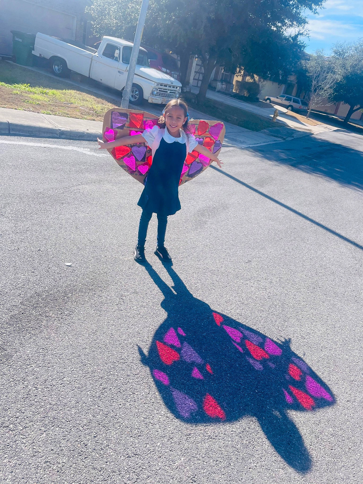 Emma is registered to the contest to win money with this photo: asphalt, automotive_wheel_system, car, city, electric_blue, fun, joy, leisure, magenta, pattern, pedestrian, person, recreation, road, road_surface, rolling, shadow, sidewalk, sky, tints_and_shades