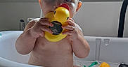 Jayce is registered to the contest to win money with this photo: baby, baby_bath, bath_time, bath_toy, bathtub, blue_eyes, child, home, indoor, infant, playful, portrait, rubber_duck, sitting, sunlight, toy, water, wet, wide_eyed, window