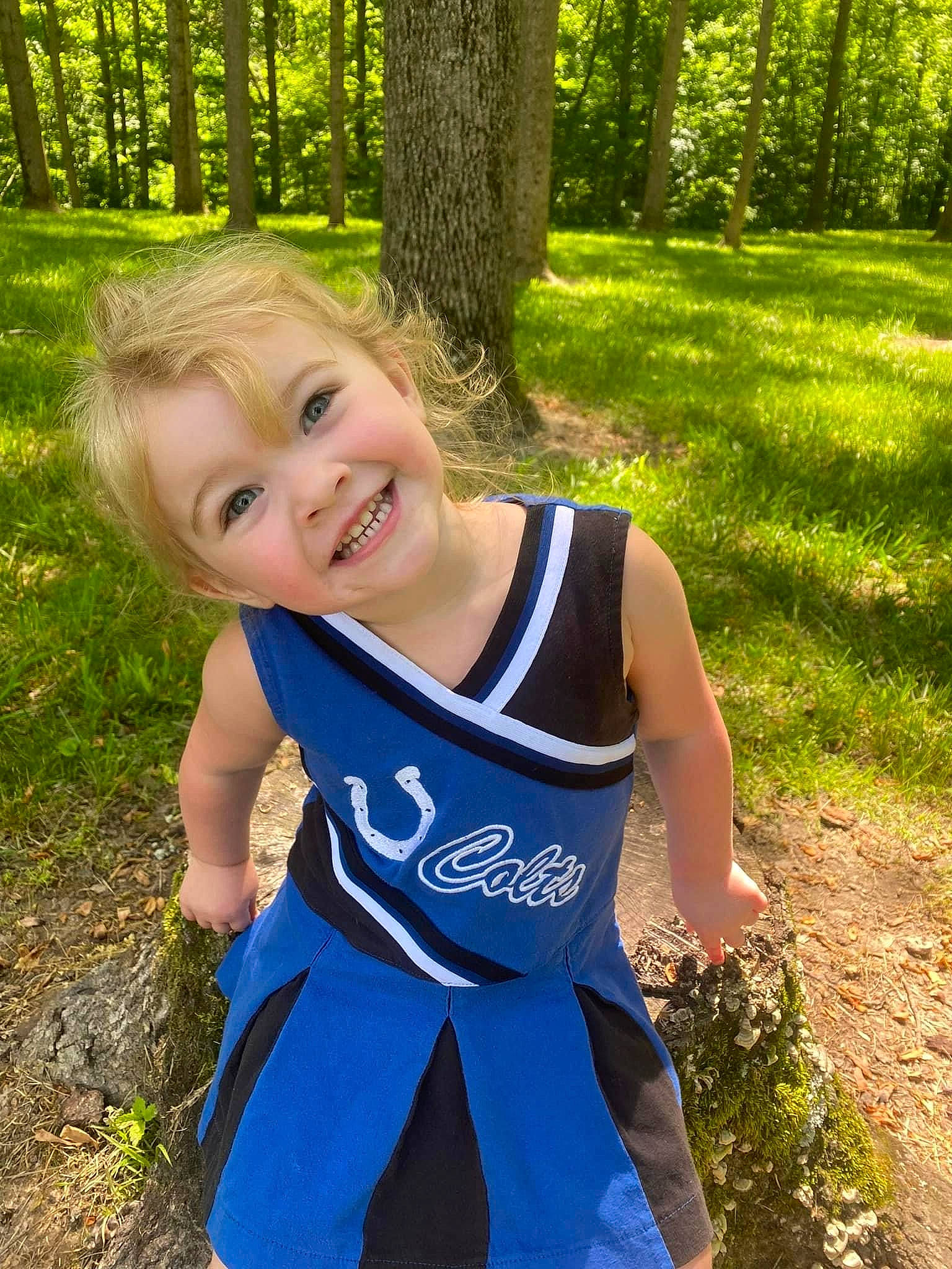 Braylee is registered to the contest to win money with this photo: baby_toddler_clothing, electric_blue, fun, grass, green, happy, joy, leaf, leisure, light, natural_landscape, people_in_nature, person, plant, recreation, smile, summer, sunlight, t_shirt, toddler