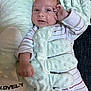 amused, baby, child, comfort, cozy, curious, cushion, expression, face, hand, indoor, infant, lying_down, onesie, pillow, plush, sleepwear, soft_toy, striped_clothing, texture
