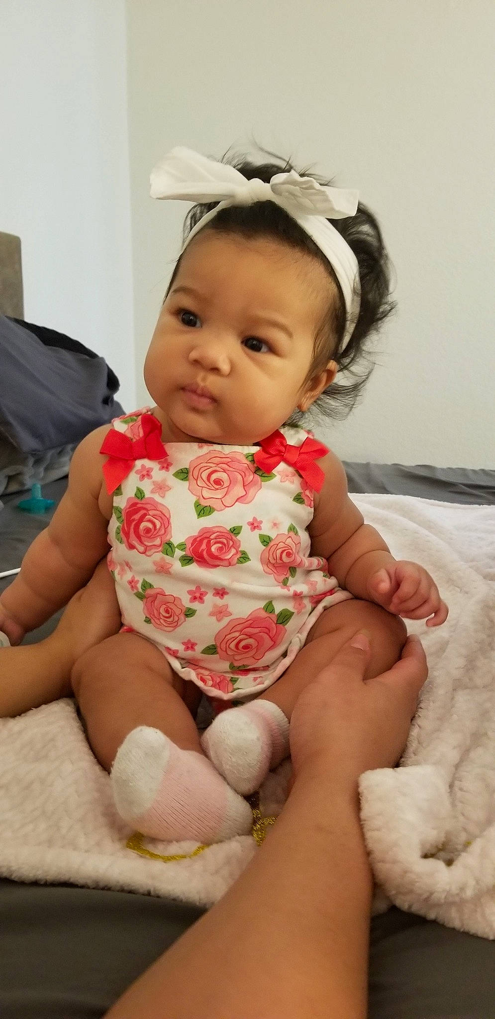 Amara is registered to the contest to win money with this photo: baby, baby_products, baby_toddler_clothing, cheek, child, hair_accessory, headgear, person, sitting, skin, smile, toddler