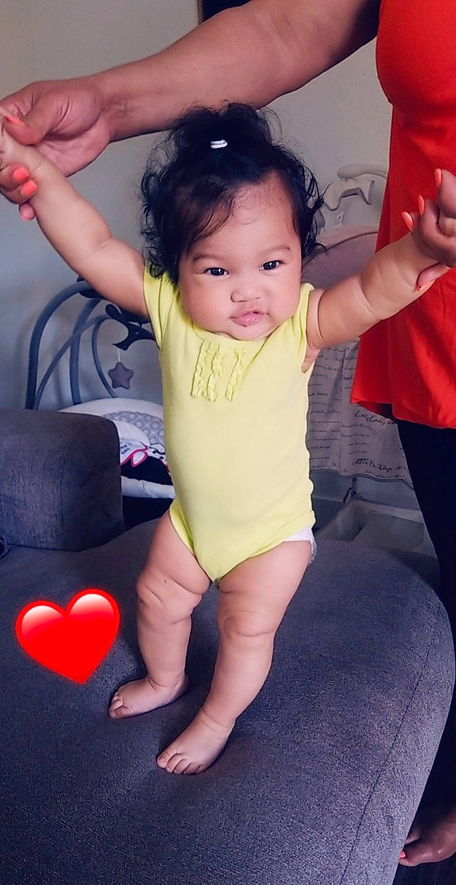 Amara is registered to the contest to win money with this photo: arm, baby, child, finger, human_leg, leg, neck, person, standing, thigh, thumb, toddler