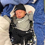 Kairo joined the competition — help win amazing prizes! baby, sleeping, infant, hat, clothing, blanket, quilt, patterned, nike, footed_pajamas, newborn, cute, resting, indoors, child, soft, warm, cozy, person, portrait