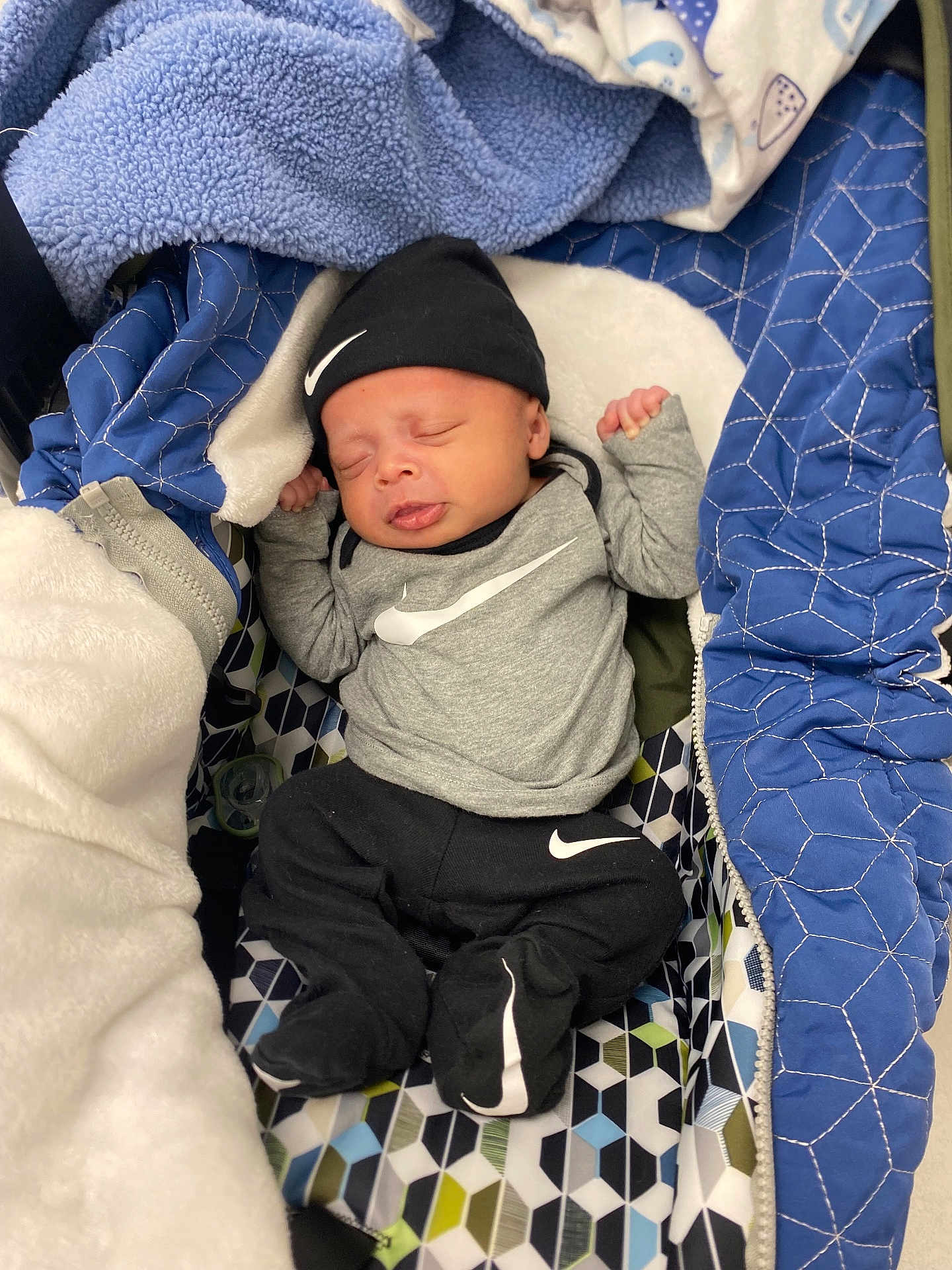 Kairo joined the competition — help win amazing prizes! baby, sleeping, infant, hat, clothing, blanket, quilt, patterned, nike, footed_pajamas, newborn, cute, resting, indoors, child, soft, warm, cozy, person, portrait