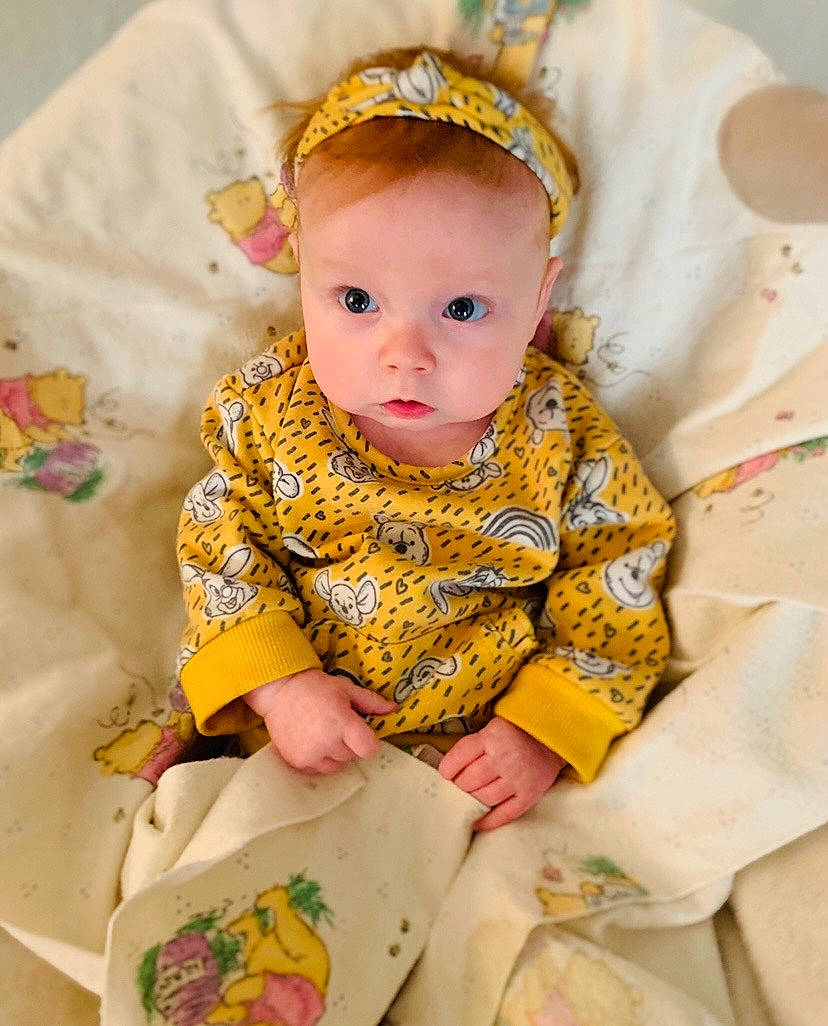 Baylor joined the competition — help win amazing prizes! baby, baby_toddler_clothing, cheek, child, dress, embellishment, eye, face, happy, iris, linens, pattern, peach, person, sitting, skin, sleeve, t_shirt, textile, toddler