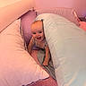 baby, pillow, bed, blanket, smile, happy, infant, indoor, child, face, head, cute, cozy, pink, quilt, cushion, playful, person, young, rest