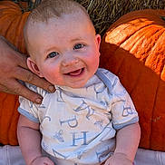 Greysen joined the competition — help win amazing prizes! baby, infant, child, smiling, happy, portrait, pumpkin, pumpkin_patch, autumn, fall, hay, outdoor, farm, rustic, onesie, sitting, adult_hand, closeup, orange, family