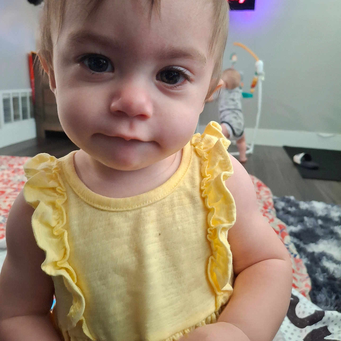 Ainsley is registered to the contest to win money with this photo: baby, background, child, closeup, clothing, curious, cute, expression, face, floor, home, indoor, infant, person, play, portrait, toddler, toy, yellow_dress, young_child