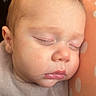 Augustus is registered to the contest to win money with this photo: baby, sleeping, infant, portrait, face, closed_eyes, peaceful, bedding, blanket, swaddled, cushion, orange, polka_dots, indoors, resting, head, cheeks, lips, soft_lighting, close_up