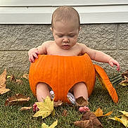 Augustus joined the competition — help win amazing prizes! baby, infant, child, pumpkin, autumn, fall, leaves, outdoor, grass, portrait, costume, halloween, orange, sitting, bare_arms, bare_feet, house_exterior, siding, stone_wall, seasonal
