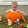 baby, infant, child, pumpkin, autumn, fall, leaves, outdoor, grass, portrait, costume, halloween, orange, sitting, bare_arms, bare_feet, house_exterior, siding, stone_wall, seasonal