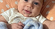 Augustus is registered to the contest to win money with this photo: baby, infant, child, portrait, smiling, happy, blue_eyes, face, close_up, indoor, blanket, cushion, polka_dots, clothing, sitting, lying_down, soft_texture, home, photography, adorable