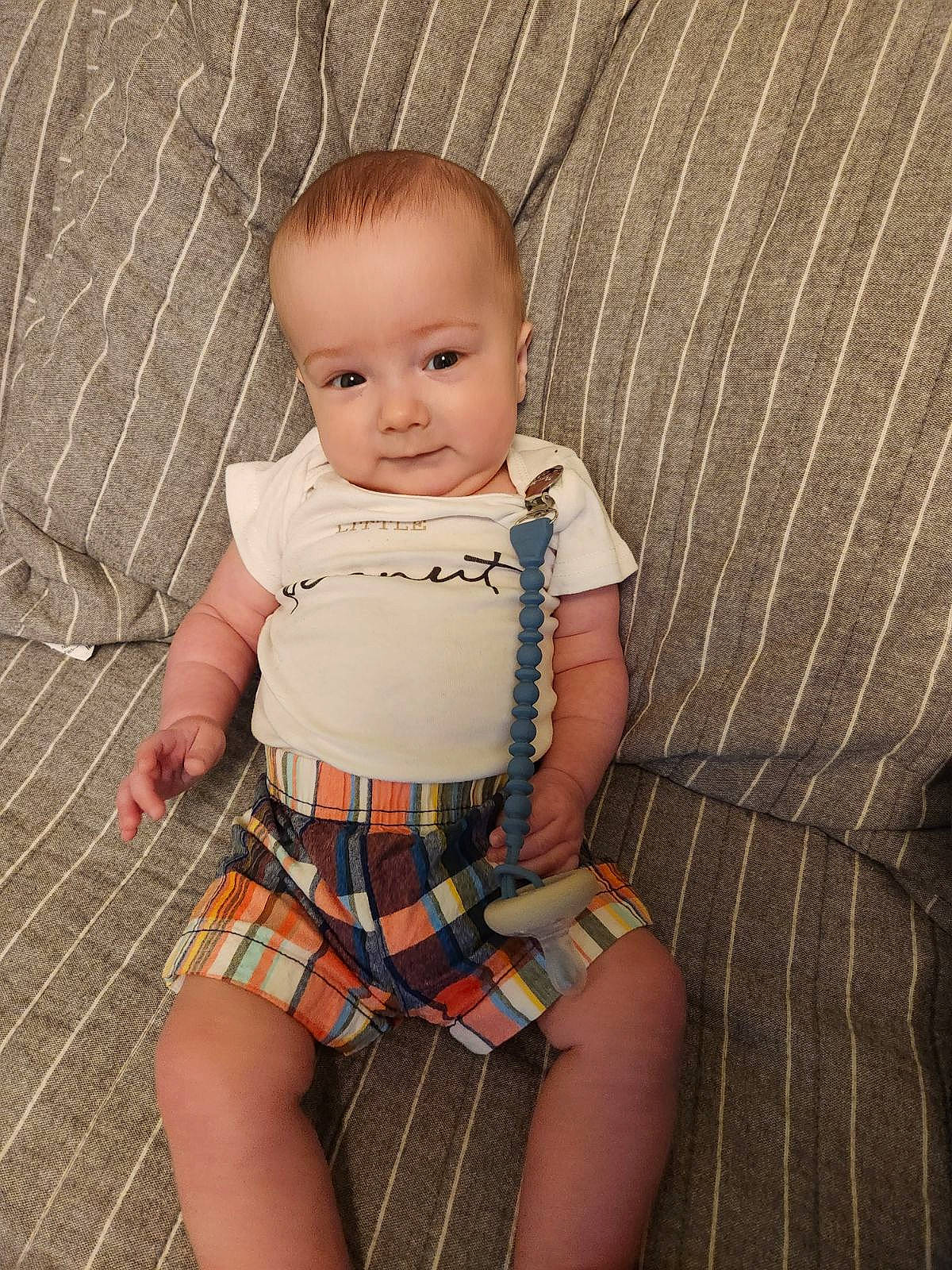 Bennett is registered to the contest to win money with this photo: baby, baby_toddler_clothing, cheek, chest, child, face, head, human_leg, knee, pattern, person, plaid, shorts, skin, sleeve, stomach, tartan, thigh, toddler, trunk