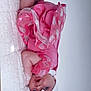 Rayah-Rose is registered to the contest to win money with this photo: baby, infant, pink_dress, white_bow, headband, blanket, lying_down, cute, soft_texture, small_hands, small_feet, portrait, indoor, child, adorable, newborn, face, expression, clothing, fabric