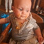 baby, child, high_chair, food, messy, striped_shirt, indoor, person, face, small_child, clothing, seat, table, wood, expression, curious, meal, stain, casual, cute