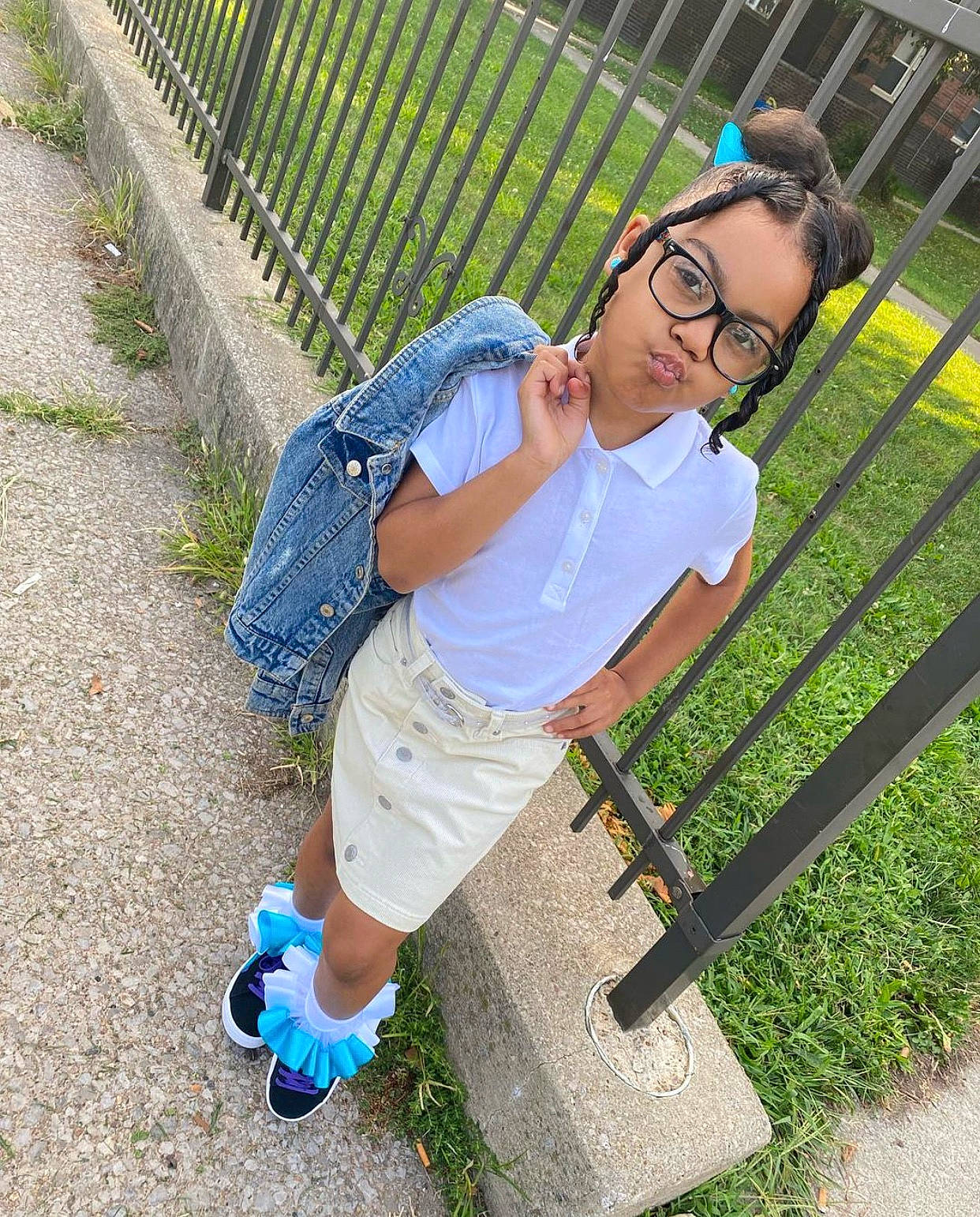 Alaya Scott is registered to the contest to win money with this photo: cool, eyewear, fence, glasses, grass, grass_family, green, joint, leaf, leisure, people_in_nature, person, plant, public_space, recreation, shoe, shorts, sneakers, t_shirt, toddler