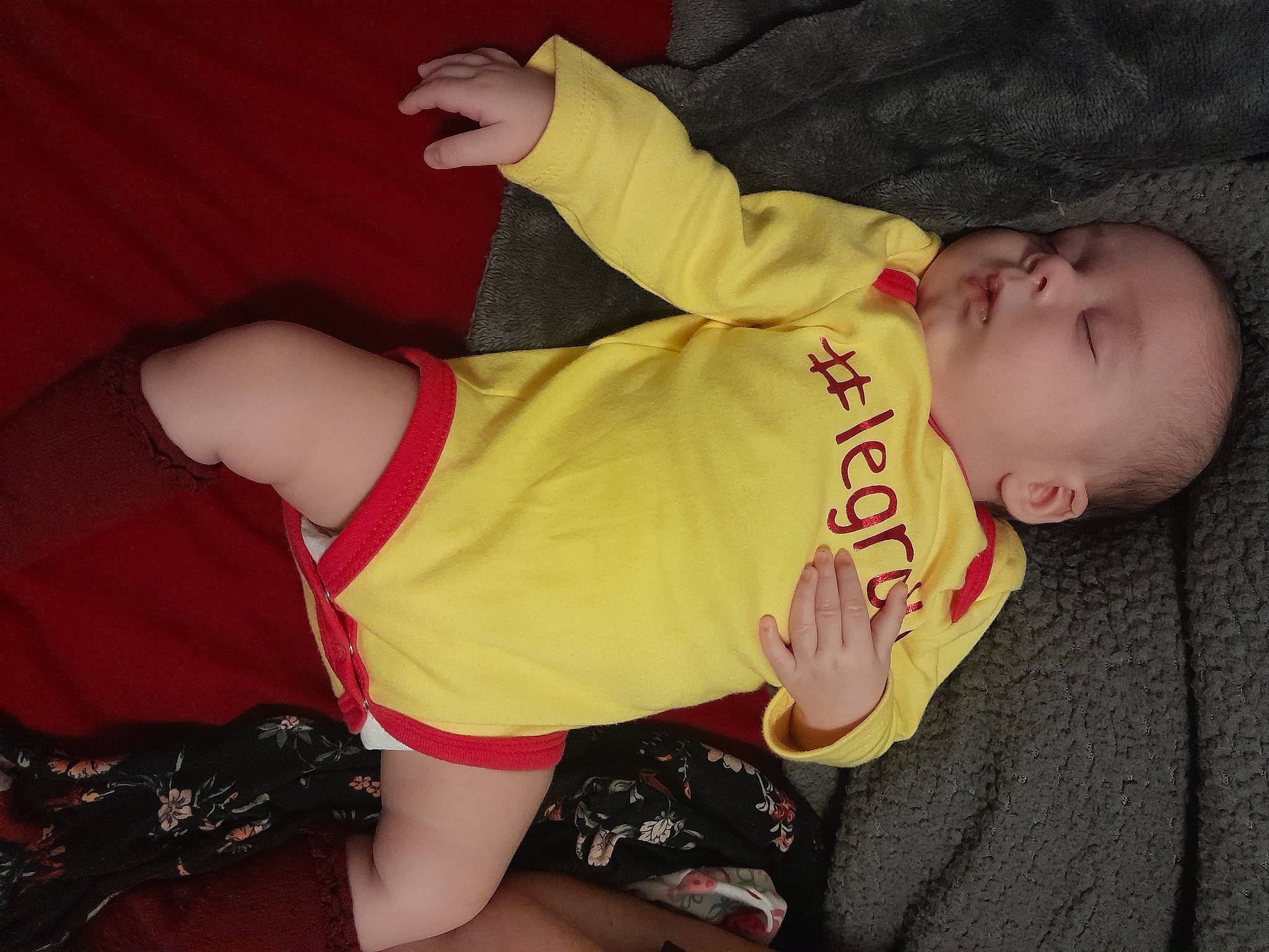 Aloy is registered to the contest to win money with this photo: abdomen, baby, baby_toddler_clothing, chest, comfort, elbow, event, facial_expression, finger, human_body, human_leg, knee, lap, person, shorts, sleeve, thigh, thumb, toddler, trunk