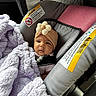baby, infant, car_seat, blanket, turban, headband, flower, portrait, face, eyes, sitting, travel, vehicle, automobile, child, cozy, lavender, safety_harness, indoor, photography