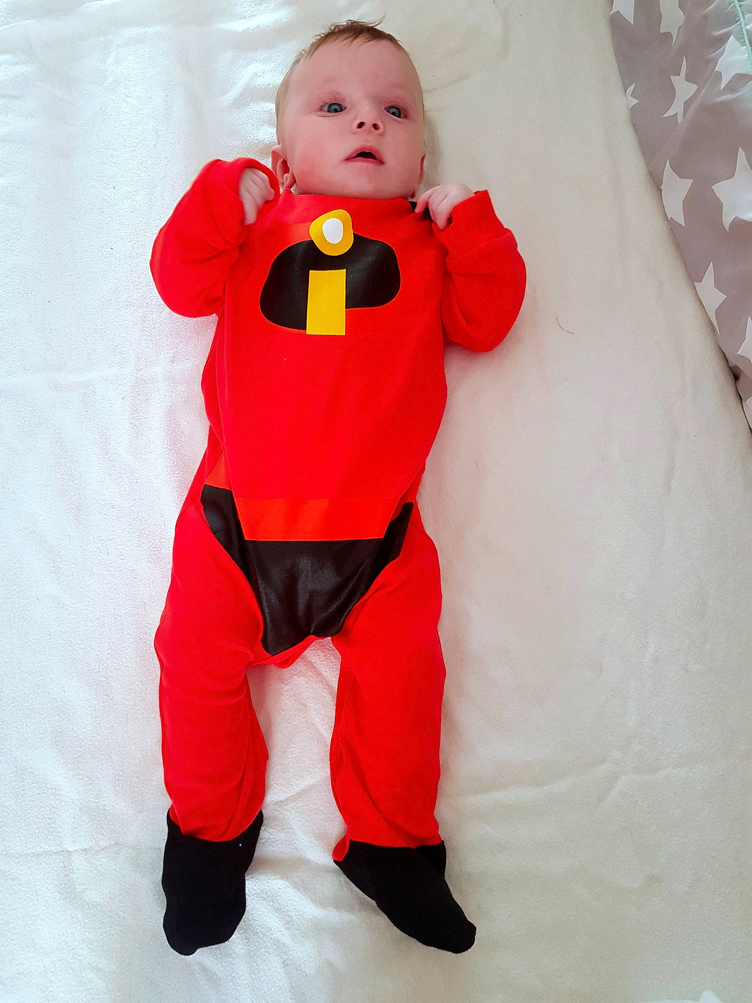 Riley is registered to the contest to win money with this photo: child, clothing, costume, fictional_character, orange, outerwear, person, personal_protective_equipment, red, toddler