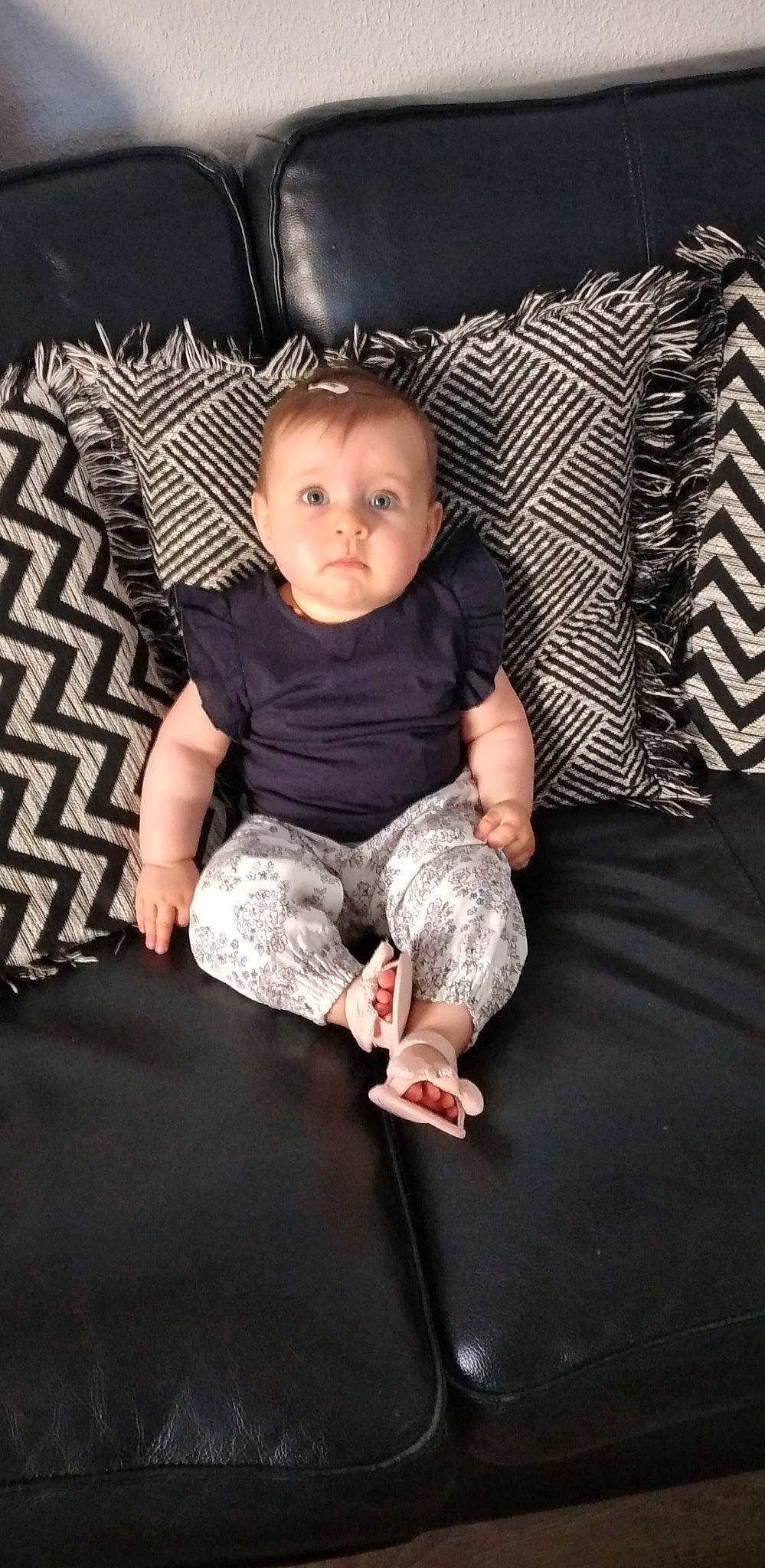 Sasha participe au concours pour gagner de l'argent avec cette photo : baby, baby_toddler_clothing, barefoot, cheek, comfort, couch, flash_photography, floor, flooring, foot, lap, leg, linens, person, skin, sleeve, sock, t_shirt, textile, toddler