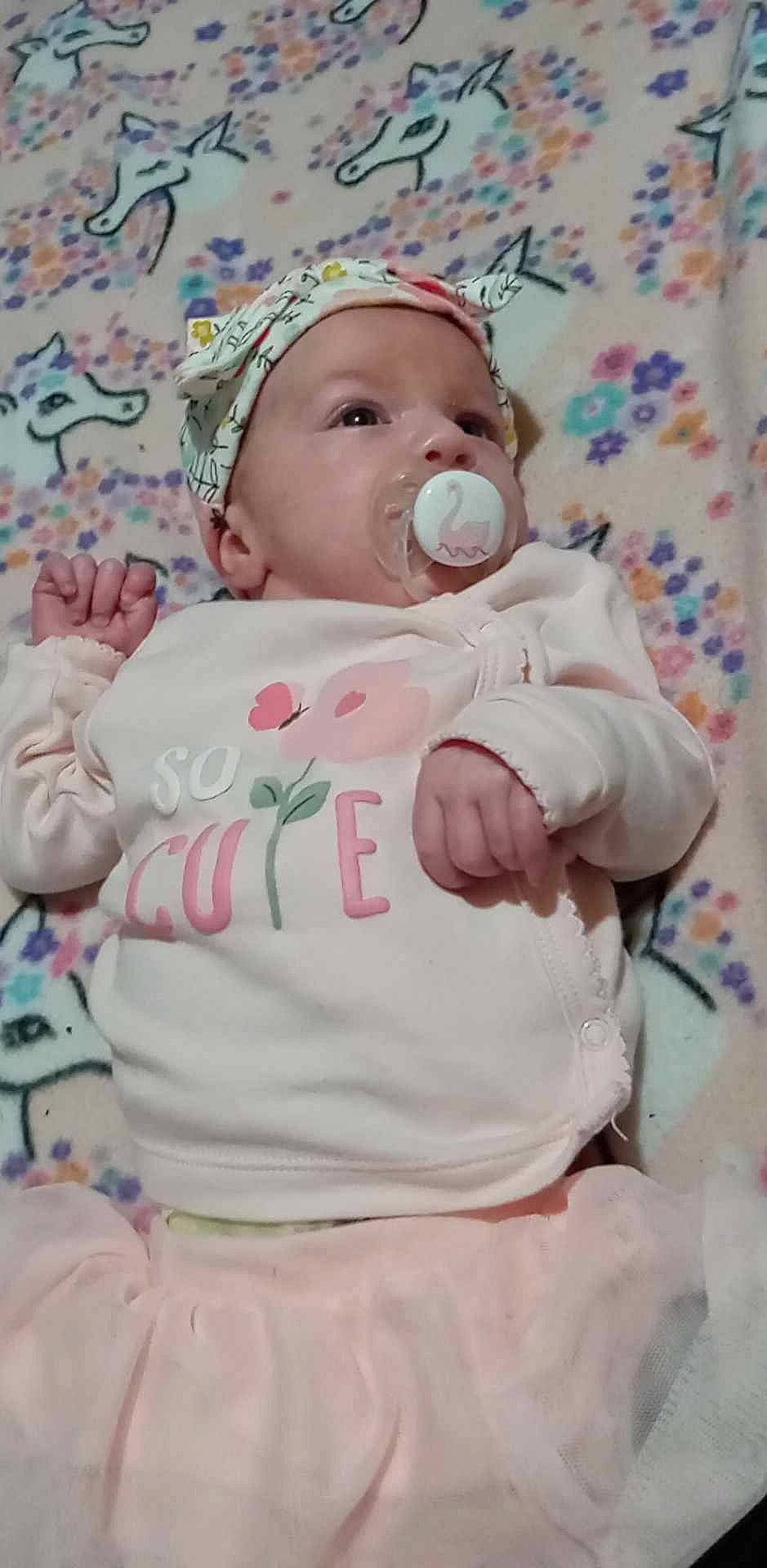 Alora joined the competition — help win amazing prizes! baby, baby_products, baby_safety, baby_sleeping, baby_toddler_clothing, cap, cheek, child, comfort, face, happy, hat, linens, pattern, person, pink, skin, sleeve, t_shirt, textile