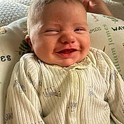 Waylon joined the competition — help win amazing prizes! baby, child, closeup, clothing, cozy, cute, expression, face, happy, head, indoor, infant, light, onesie, person, pillow, portrait, resting, smiling, zebra_pattern