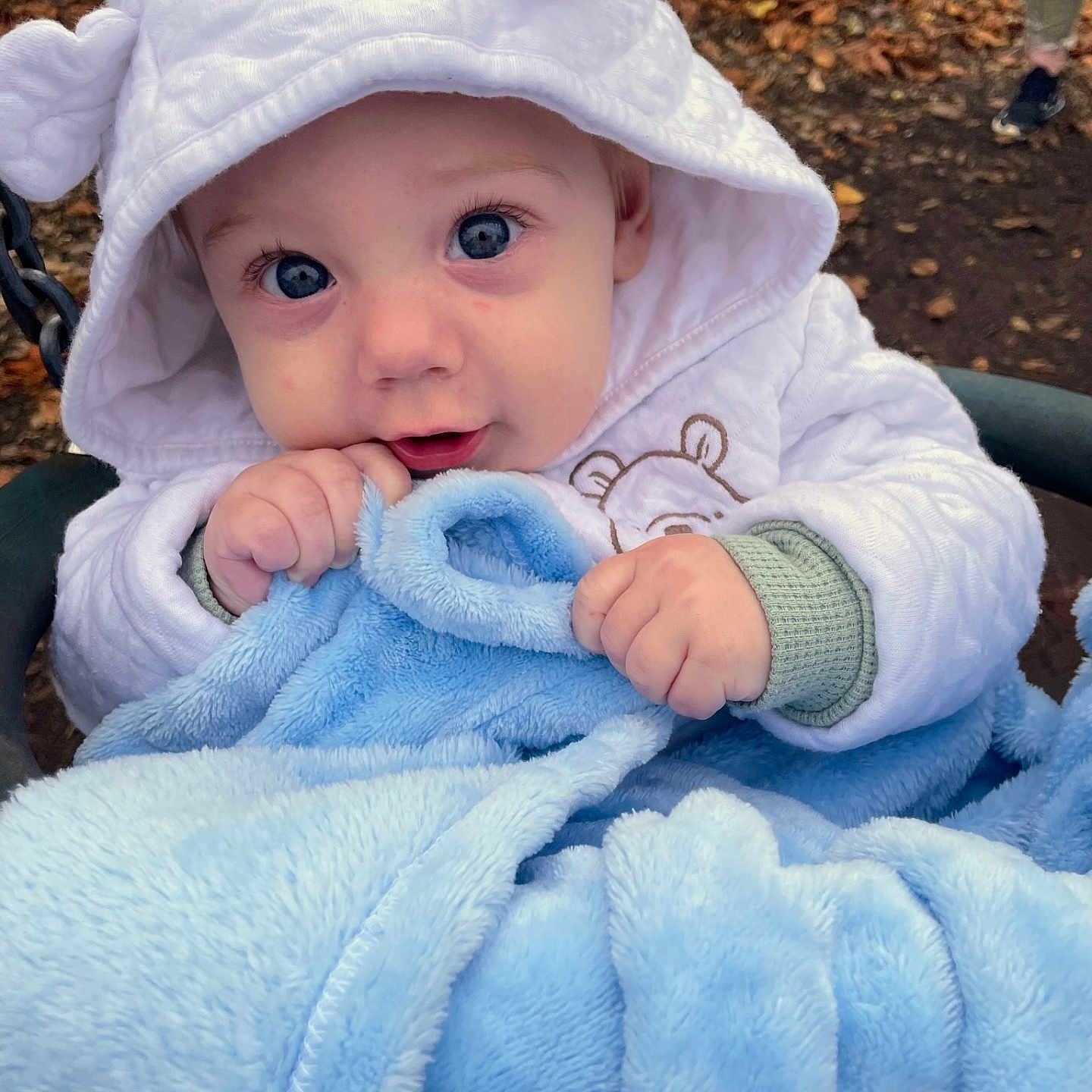 Albie-Harrison is registered to the contest to win money with this photo: baby, blanket, bonnet, clothing, coat, face, footwear, grass, hat, head, hood, hoodie, jacket, knitwear, person, photography, portrait, shoe, sweater, sweatshirt