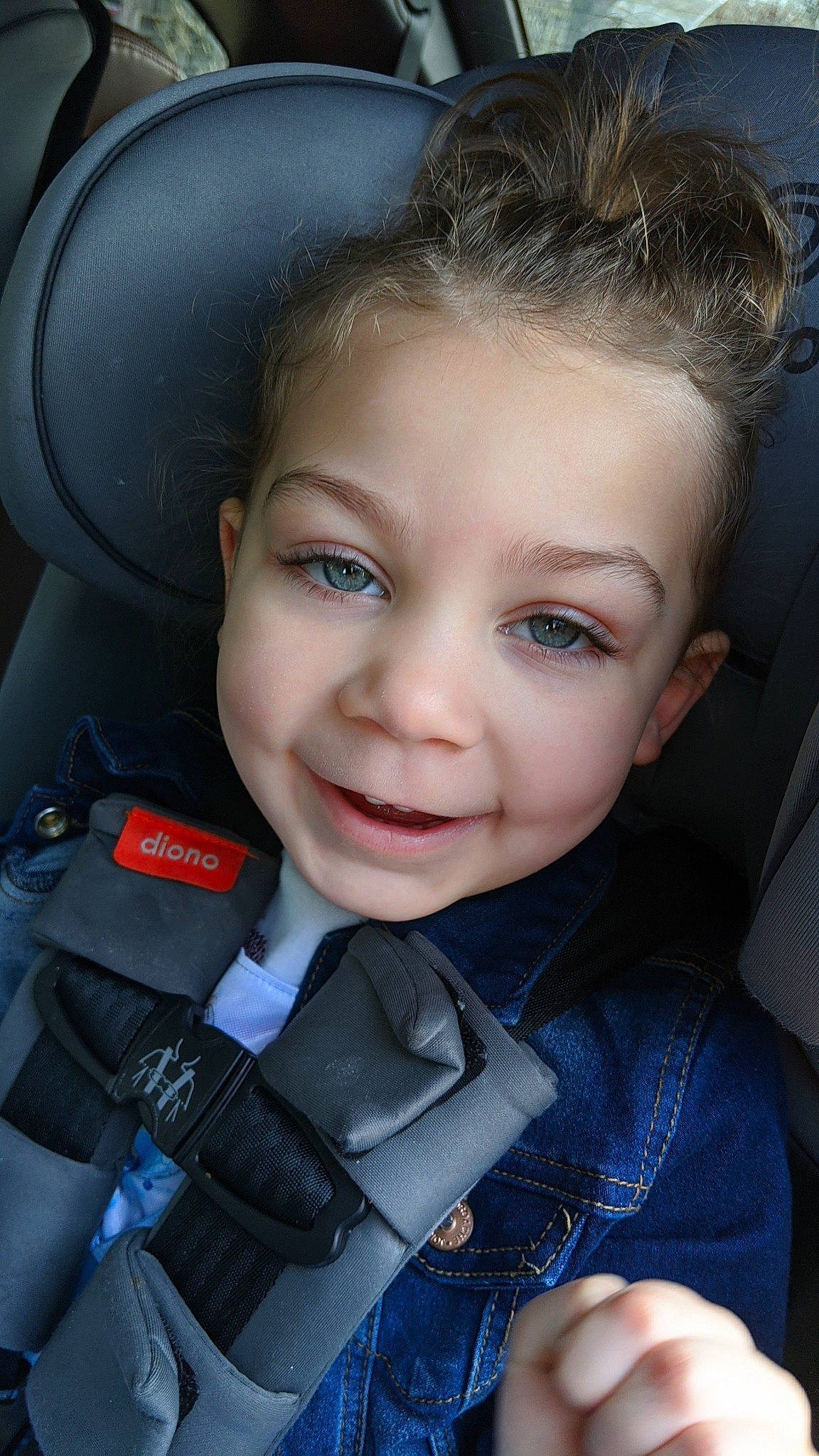 Makena is registered to the contest to win money with this photo: car_seat, cheek, child, child_model, chin, eye, eyebrow, face, facial_expression, forehead, hair, hairstyle, head, joy, lip, nose, person, photography, skin, smile