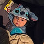 baby, child, car_seat, hoodie, blanket, blue, cute, infant, face, eyes, clothing, portrait, sitting, cozy, warm, indoor, soft_lighting, fabric, bundle, kid