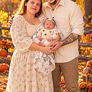 Keyleigh is registered to the contest to win money with this photo: newborn, baby, infant, couple, parents, family, portrait, outdoor, autumn, fall, pumpkin, pumpkin_patch, foliage, leaves, smiling, sleeping, baby_hat, floral_dress, tattoo, nature
