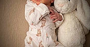 Keyleigh is registered to the contest to win money with this photo: newborn, baby, sleeping, plush_toy, stuffed_bunny, portrait, indoors, onesie, infant, peaceful, cute, face, closed_eyes, cuddling, nursery, soft_blanket, lying_down, pastel_clothing, rabbit_pattern, cozy