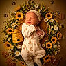 Keyleigh is registered to the contest to win money with this photo: newborn, baby, sleeping, portrait, floral_arrangement, sunflowers, daisies, flowers, bees, honeycomb, beehive, honey, nature, yellow, white, onesie, headband, peaceful, overhead_view, studio_photography