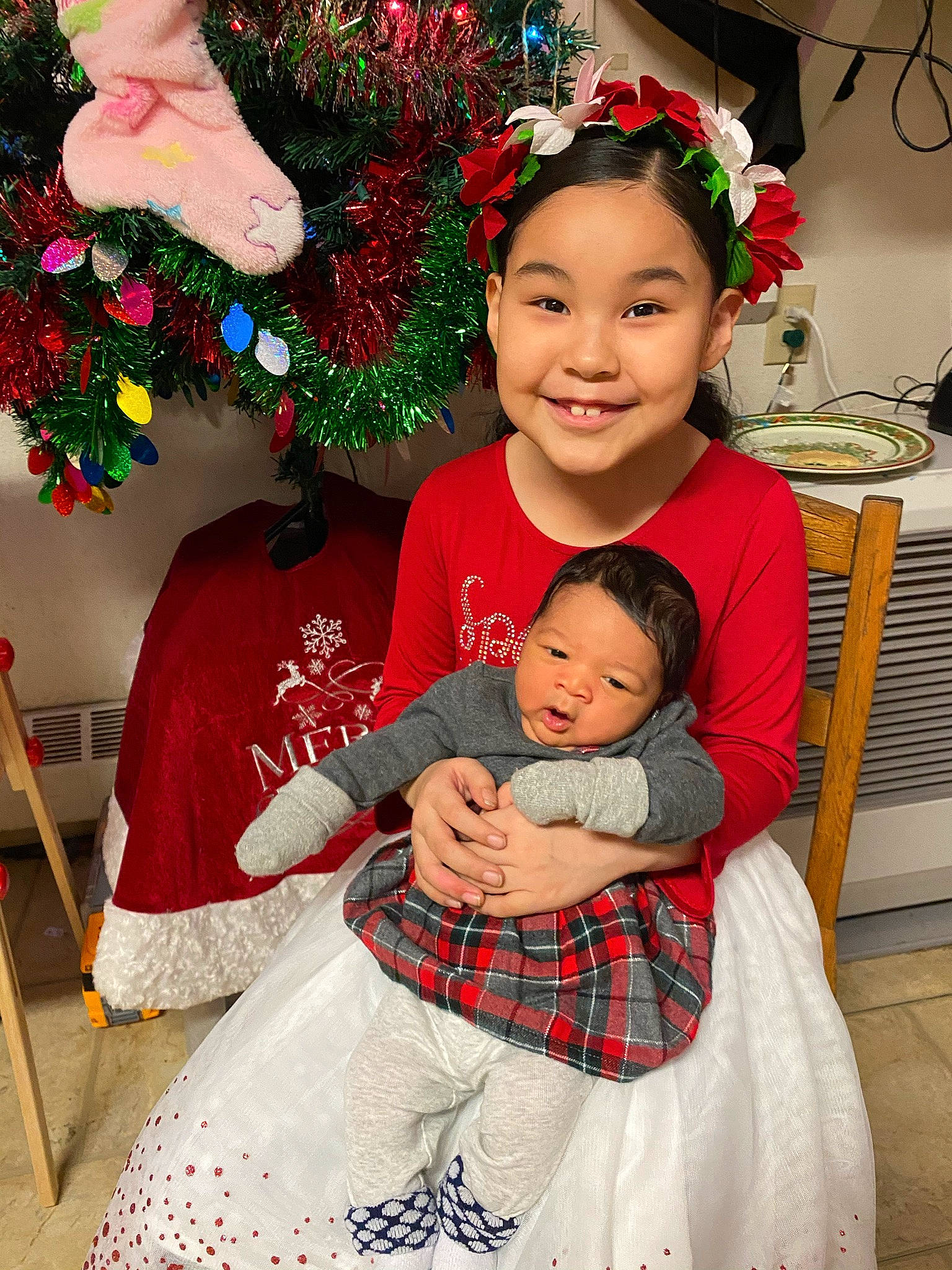 Priscilla joined the competition — help win amazing prizes! baby, baby_toddler_clothing, chair, christmas_decoration, christmas_eve, christmas_ornament, event, eye, face, happy, head, holiday, joy, person, pink, plant, red, sleeve, smile, toddler