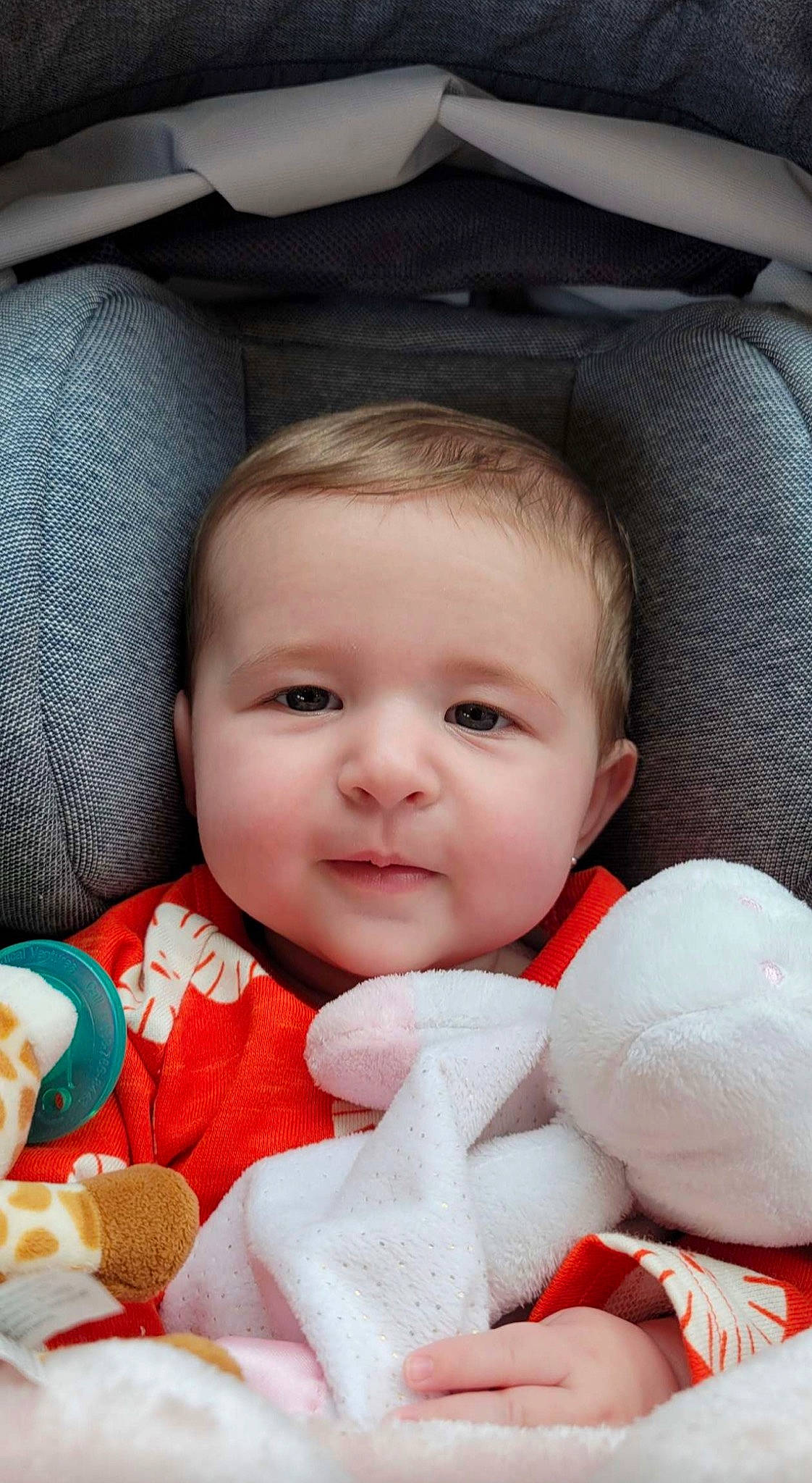 Joelle is registered to the contest to win money with this photo: baby, baby_in_car_seat, baby_toddler_clothing, beauty, car_seat, cheek, child, comfort, eye, finger, happy, iris, lip, mouth, nose, person, product, skin, textile, toddler