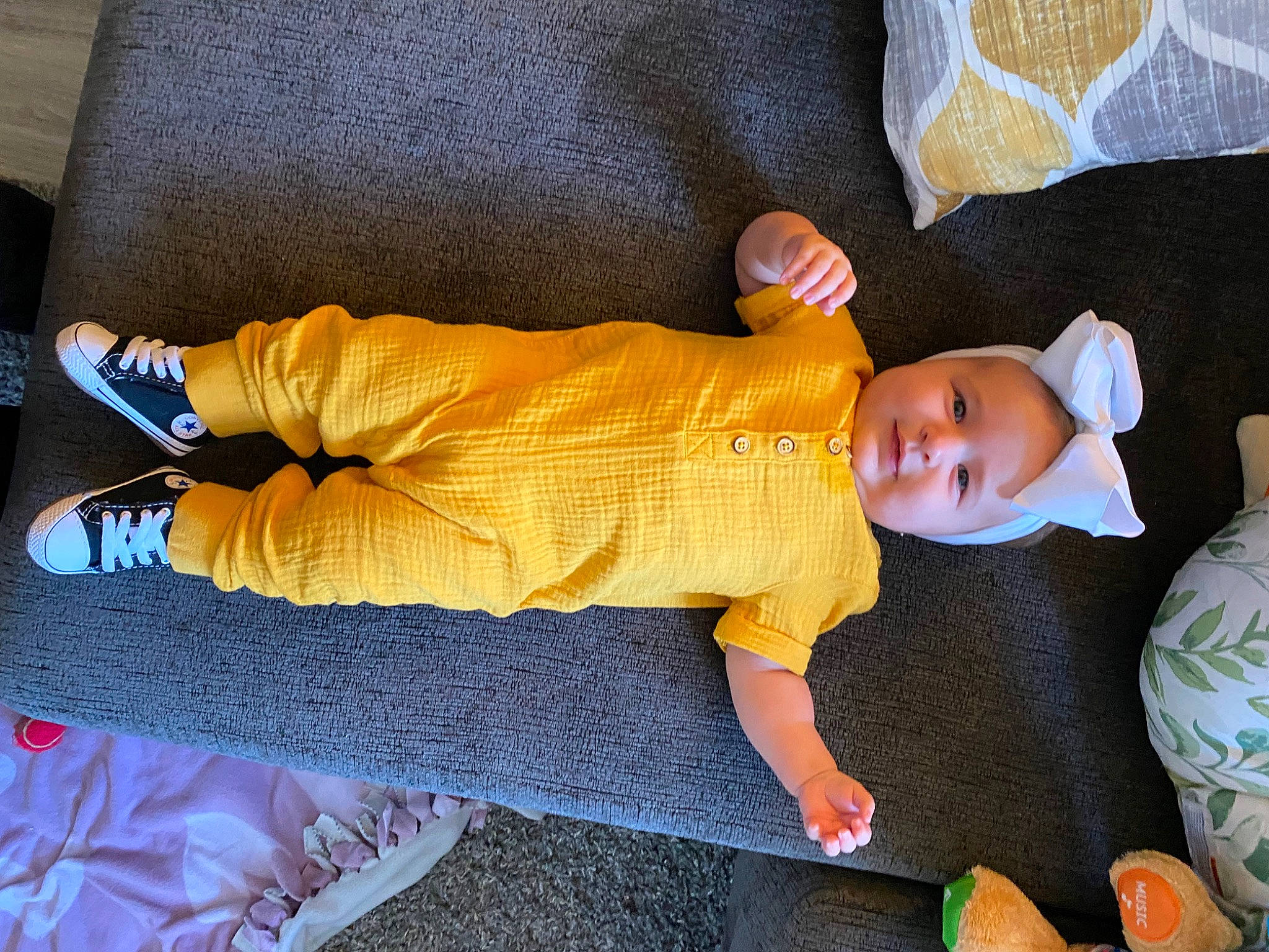 Joelle is registered to the contest to win money with this photo: baby, baby_products, baby_sleeping, baby_toddler_clothing, baby_toys, child, comfort, finger, floor, flooring, headgear, human_body, human_leg, leg, linens, mammal, orange, person, sleeve, sock