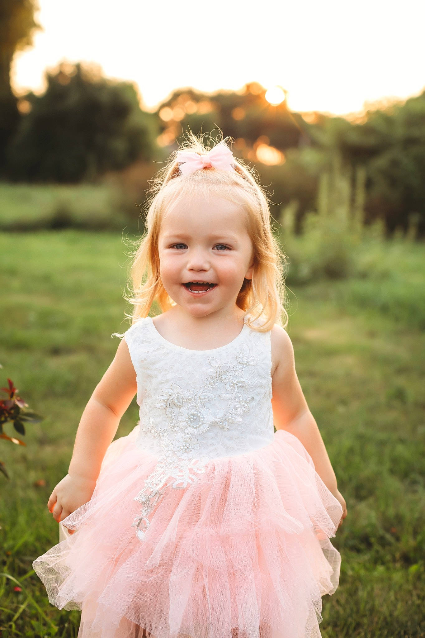 Karley is registered to the contest to win money with this photo: baby, baby_toddler_clothing, dress, eye, face, flash_photography, grass, hair, happy, iris, joy, light, people_in_nature, person, photograph, plant, skin, sky, smile, standing