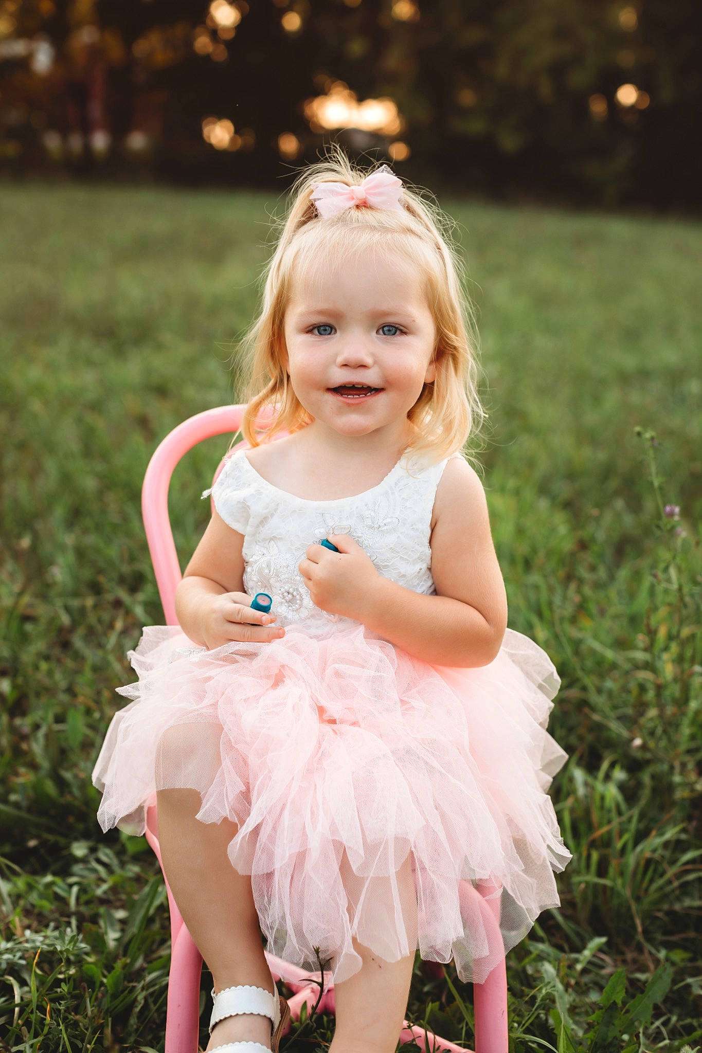 Karley is registered to the contest to win money with this photo: baby_toddler_clothing, child, clothing, dress, eye, face, flash_photography, grass, hairstyle, happy, iris, joy, light, people_in_nature, person, photograph, pink, plant, skin, smile