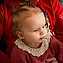 toddler, child, person, face, hair, pigtails, lace_collar, sweater, red_hoodie, hand, tattoo, portrait, indoor, closeup, skin, blue_eyes, cute, warm, family, seated