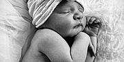 Ellie joined the competition — help win amazing prizes! baby, newborn, sleeping, headband, flower, blanket, soft_texture, black_and_white, portrait, child, infant, peaceful, cute, skin, closeup, resting, tulle, hands, face, hair