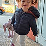 Lily participe au concours pour gagner de l'argent avec cette photo : child, girl, pigtails, smiling, jacket, stuffed_toy, bunny, outdoor, sidewalk, door, building, shoes, pants, toy, happy, walking, daylight, person, cute, young